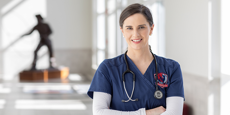Girl in scrubs with stethoscope around neck