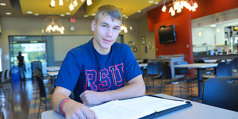 boy studying in cafeteria