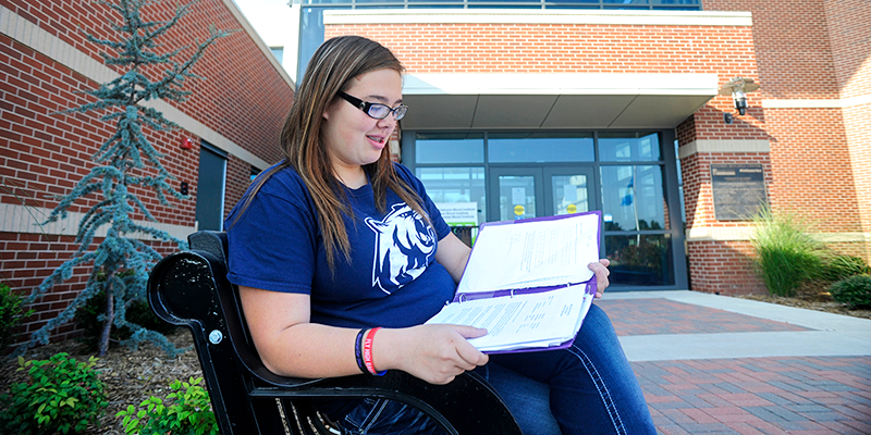 girl studying on bench