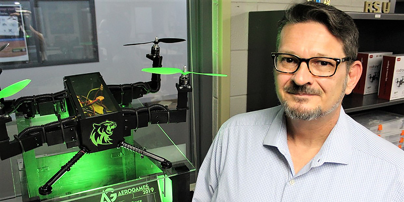 Mr. Curtis Sparling standing next to a drone