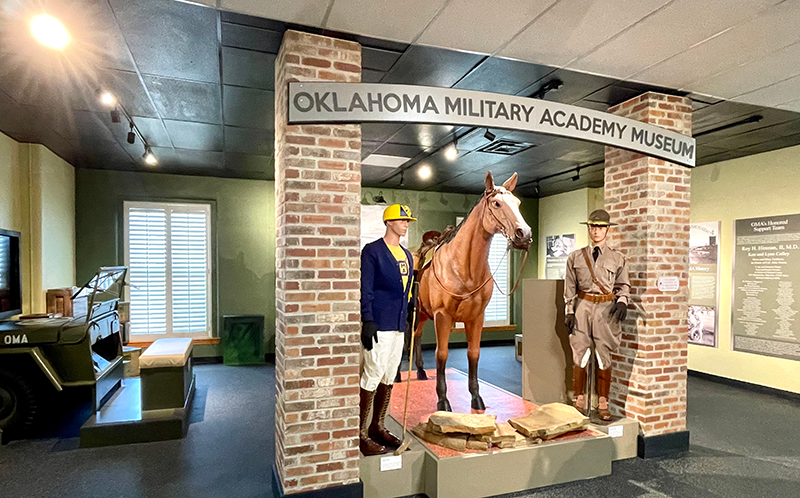 statue of men standing next to horse