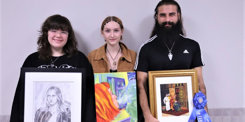 artist holding their artwork