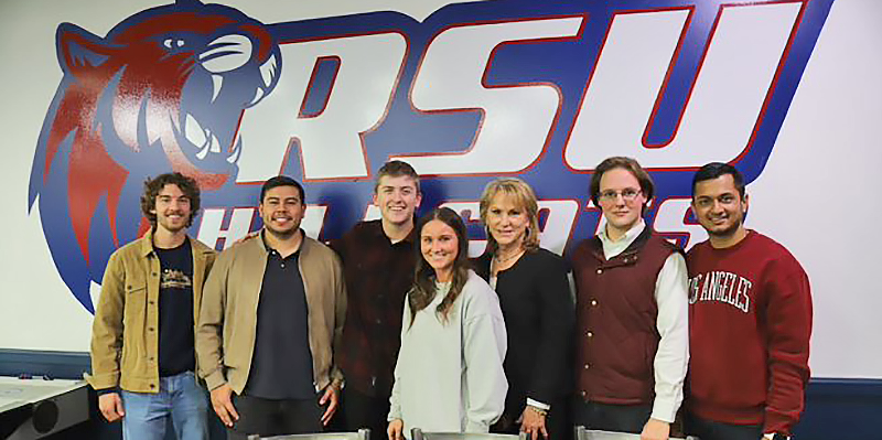 group standing under RSU sign