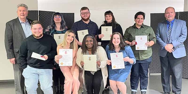 Group of people holding certificates