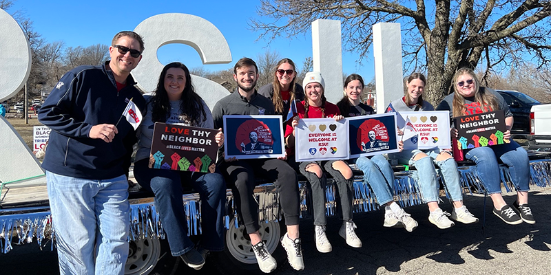 people holding signs in parade