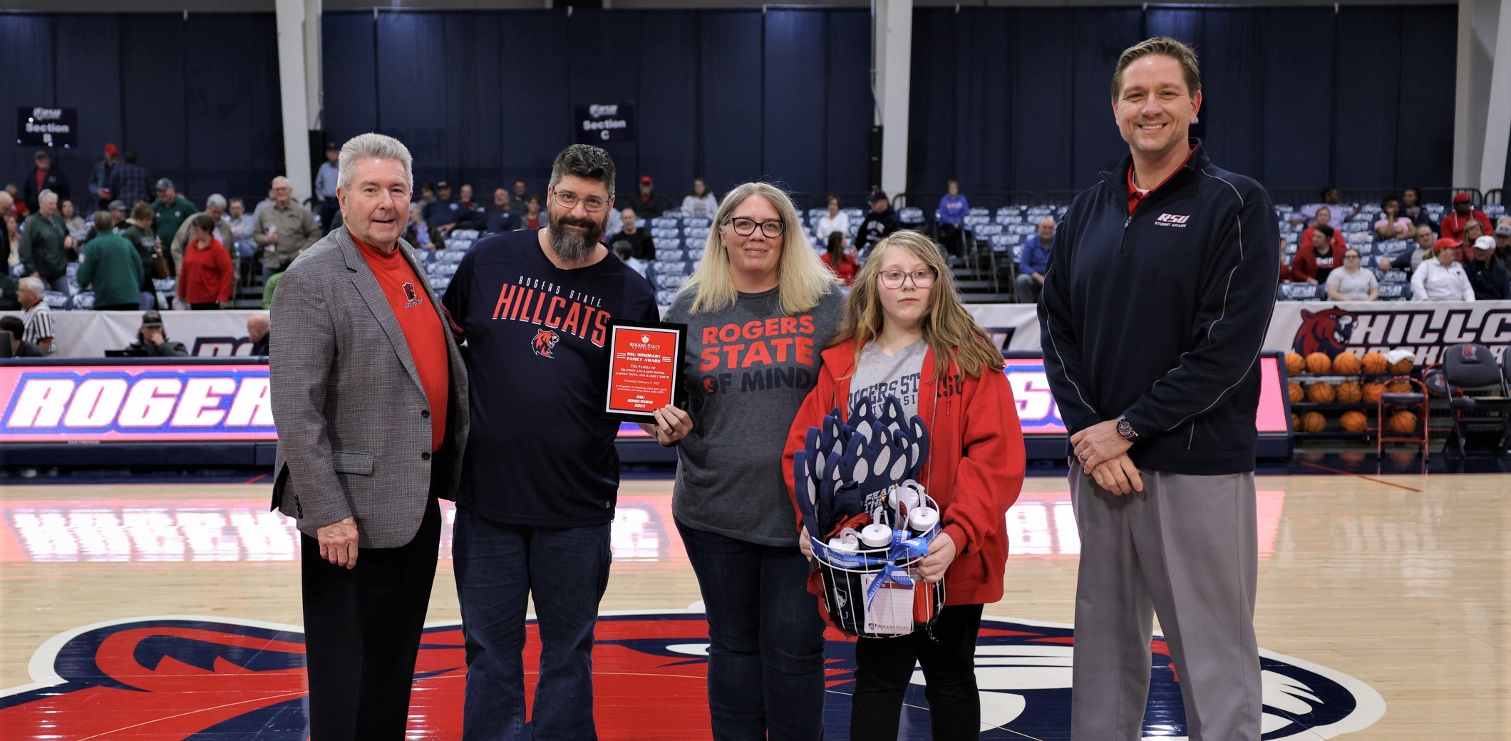 RSU President Dr. Larry Rice (from left) and Vice President for Student Affairs and Admissions Services Dr. Robert Goltra (right) present the Smith family with the 2023 RSU Honorary Family Award. Family members include Jason and Shannon Smith and their daughters, Aubrey and (not pictured) Ashten. 