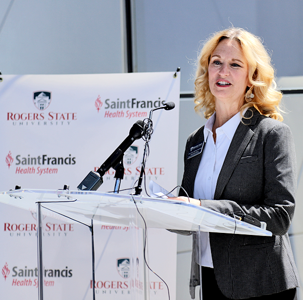 Dr. Carla Lynch speaking at podium