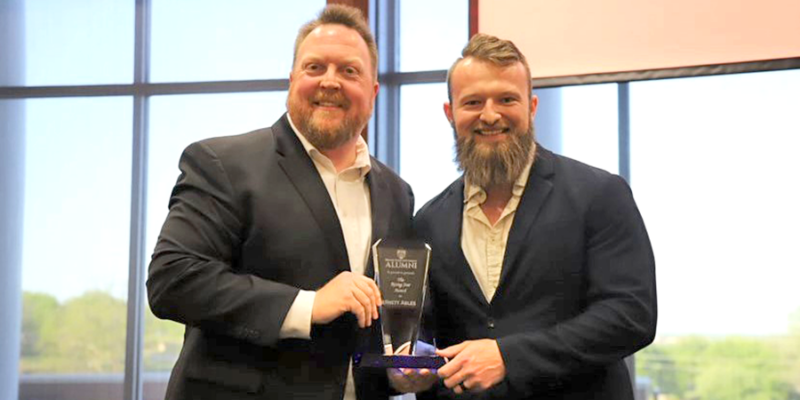 men holding award