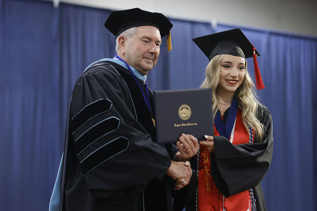 girl getting diploma at graduation