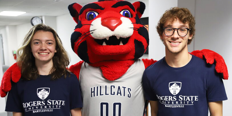 two college kids with mascot
