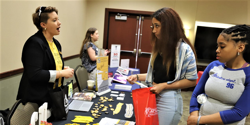 Students vising booths at a college fair