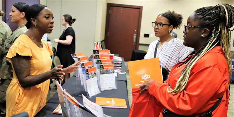 Students vising booths at a college fair