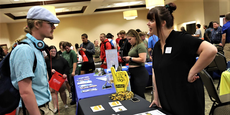 Students vising booths at a college fair