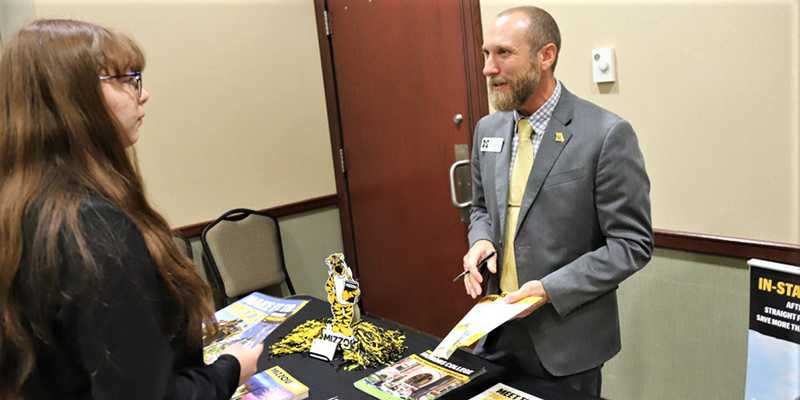 Students vising booths at a college fair