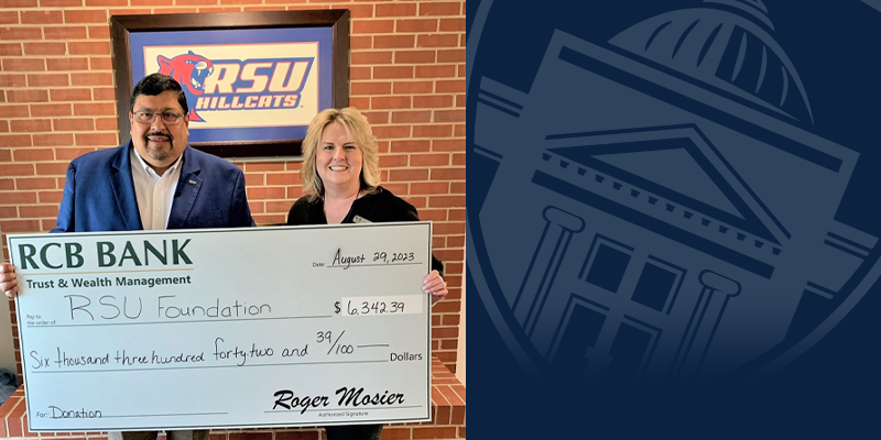 man and woman holding a large check