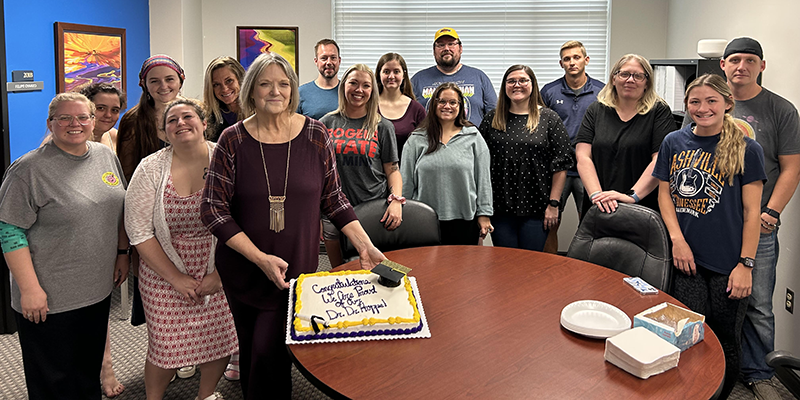 group celebrating with cake