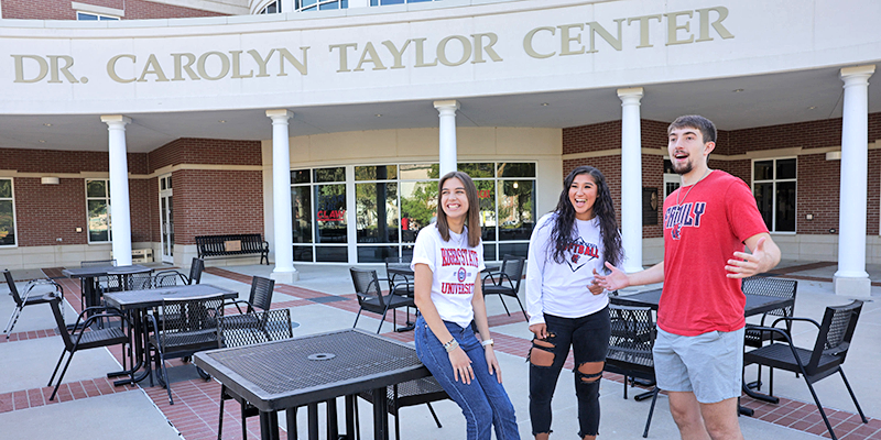 students laughing on patio