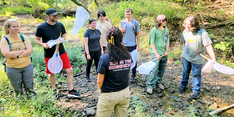 students in the field learning about reptiles and amphibians