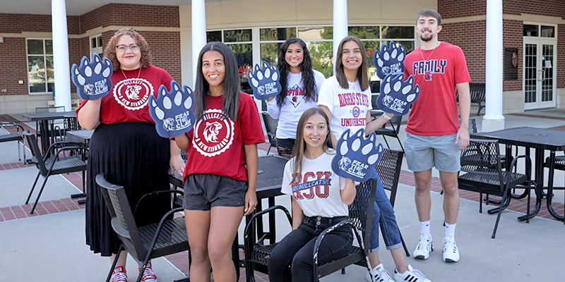 group of college students with paw foam hands