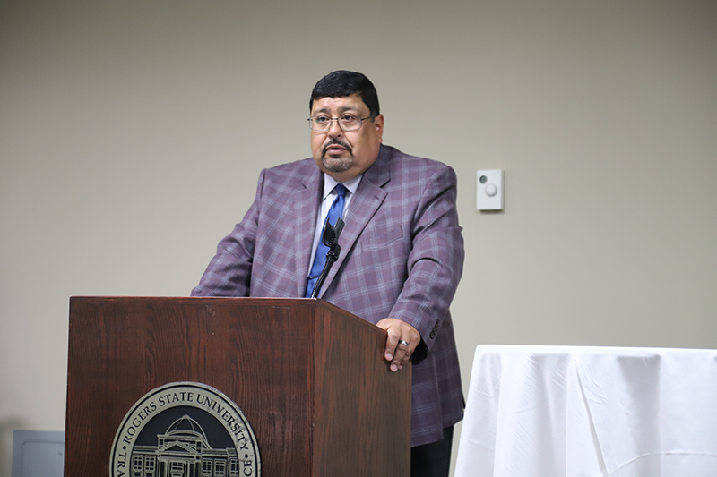 man speaking at podium