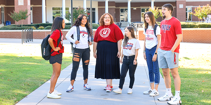 Group of students talking on college campus