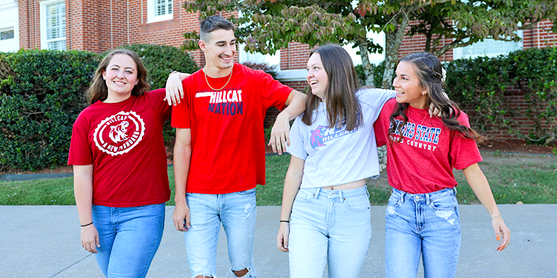 Students laughing with arms around each other.