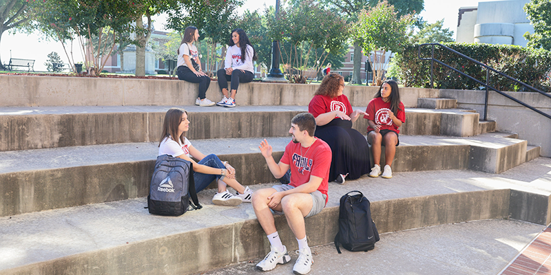 Group of students sitting on steps outside