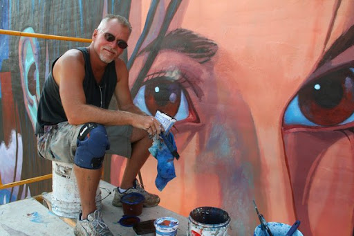 man painting mural