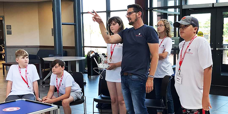 RSU Technology & Justice Studies Department Head Curtis Sparling (center) with learners at a drone seminar held at Rogers State University.