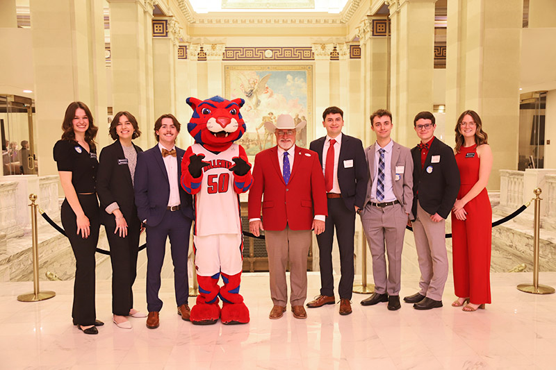 students posing with mascot in capitol rotunda