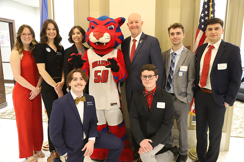students posing with mascot in capitol rotunda