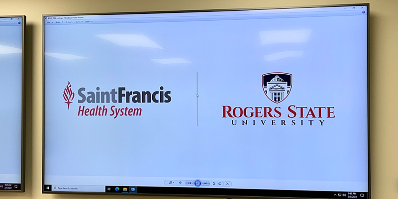 Saint Francis and RSU logos on white board screen