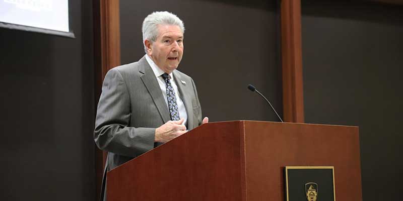 Man speaking at podium.