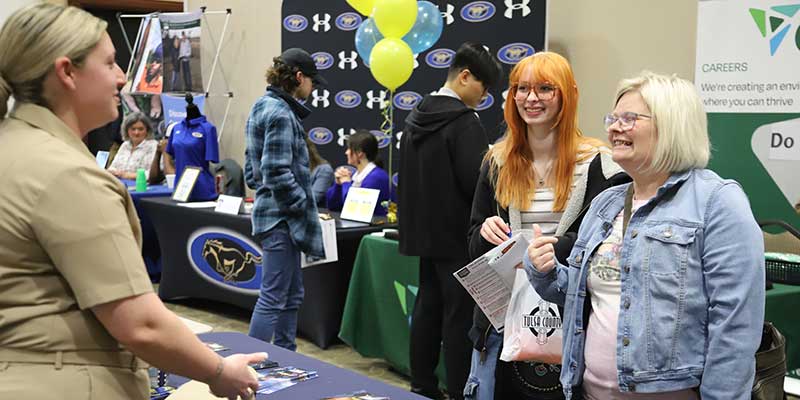 Woman talking to others at a career fair