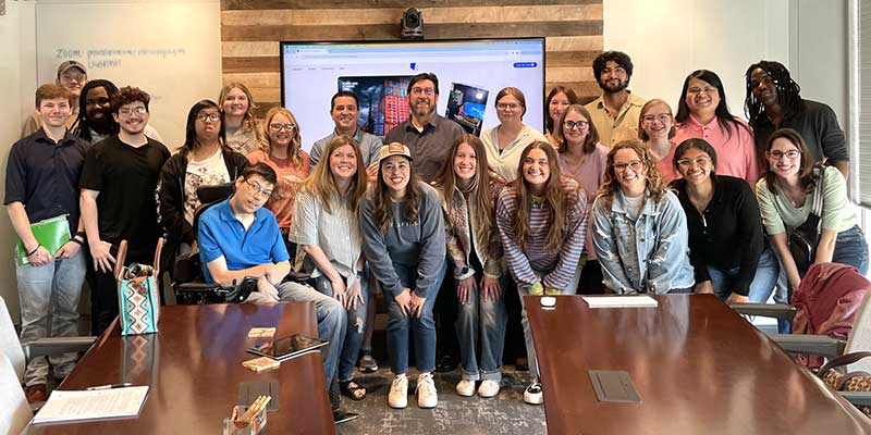 Graphic arts students posing with Littlefield Ad Agency.