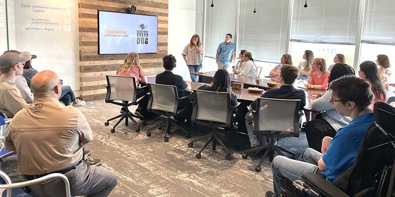 Graphic arts students listening to presentation at Littlefield Ad Agency.