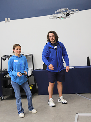 Student and instructor flying a drone.