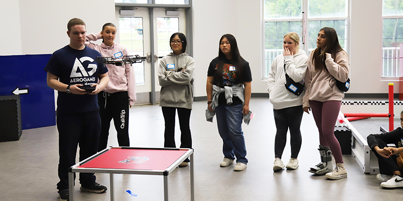 Student and instructor flying a drone.