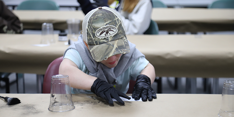 Students learning how to do fingerprinting.