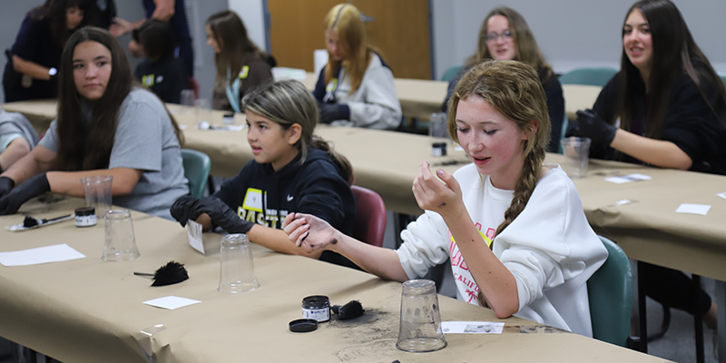 Students learning how to do fingerprinting.