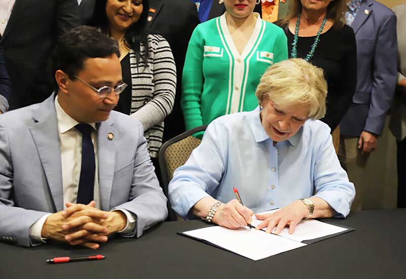 Susan Kirtley, executive director of the RSU Foundation signing papers.