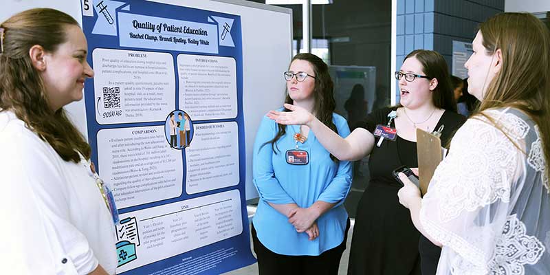 Group discussion around a poster presentation.