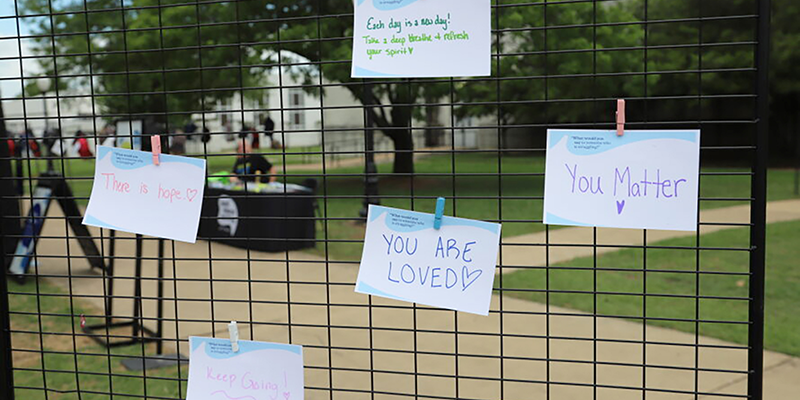 Positive notes clipped to fence