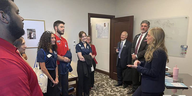 A group of people talk in an office