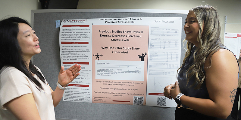 A female student and a female professor talk to each other.