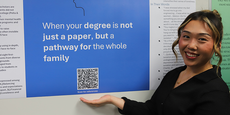 A smiling female student, showcasing her research work.