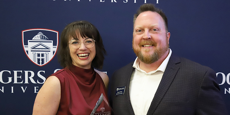 A smiling woman and a smiling man