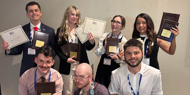 Seven RSU students pose with awards