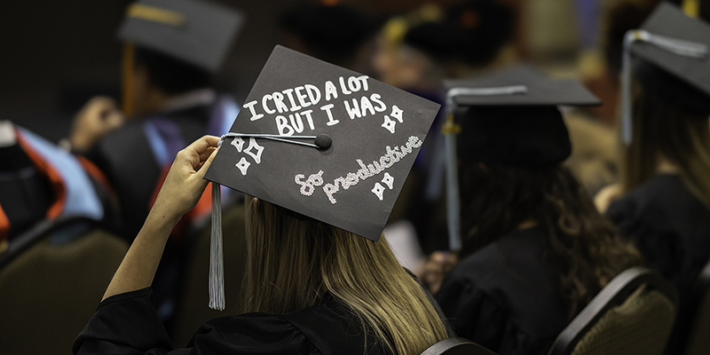 The top of a graduate's cap, with the words "I cried a lot but I was so productive."