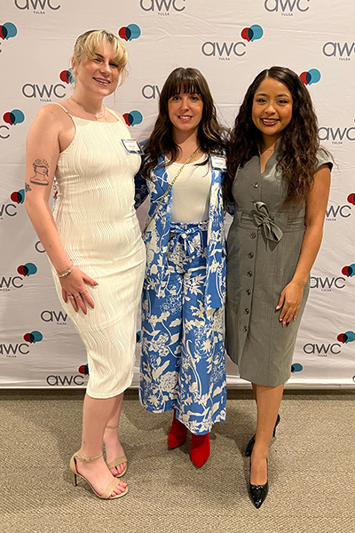Three smiling women pose for a photo